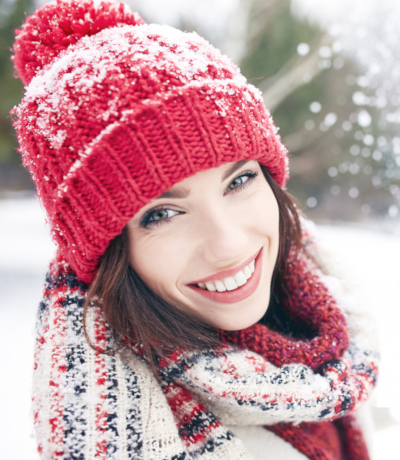 Smily girl outdoors in winter with Edelweiss serum